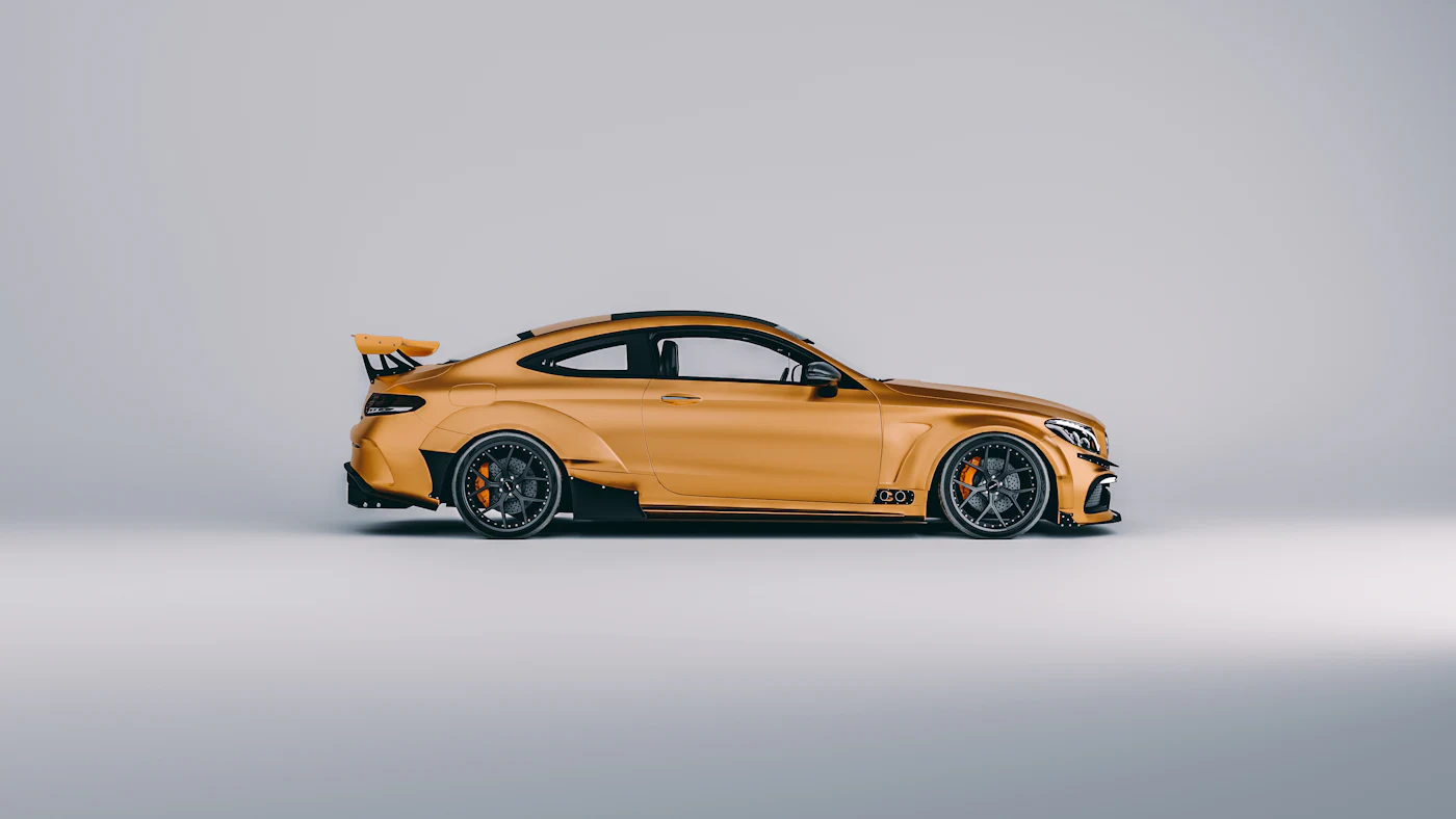 Orange widebody coupe on a grey studio backdrop